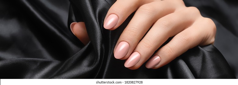 Female Hand With Pink Nail Design. Woman Hand On Black Fabric Background. Advertising Banner Ad.