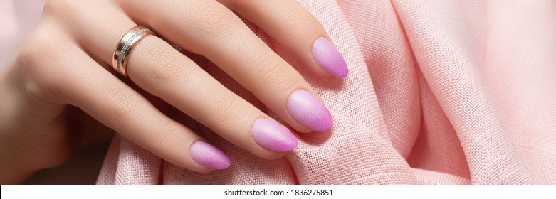 Female Hand With Pink Nail Design. Pink Nail Polish Manicure. Woman Hand On Rose Fabric Background, Banner