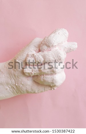 Female hand in pink paint showing  fig sign, modern art, abstract