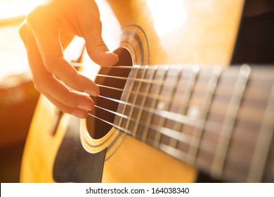 Female hand playing on acoustic guitar. Close-up. - Powered by Shutterstock