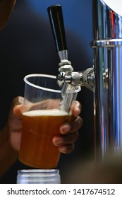 Female Hand Pouring A Beer From A Beer Tap