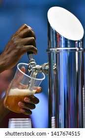 Female Hand Pouring A Beer From A Beer Tap