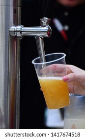 Female Hand Pouring A Beer From A Beer Tap