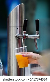 Female Hand Pouring A Beer From A Beer Tap