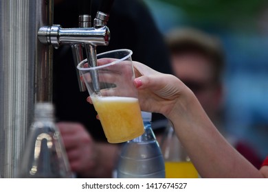 Female Hand Pouring A Beer From A Beer Tap