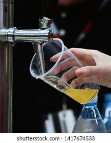 Female Hand Pouring A Beer From A Beer Tap