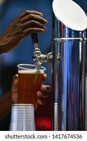 Female Hand Pouring A Beer From A Beer Tap