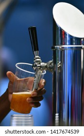 Female Hand Pouring A Beer From A Beer Tap