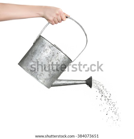 Female hand pouring water from metal watering can, isolated on white