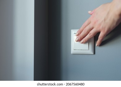 Female hand pressing light switch in apartment closeup - Shutterstock ID 2067560480