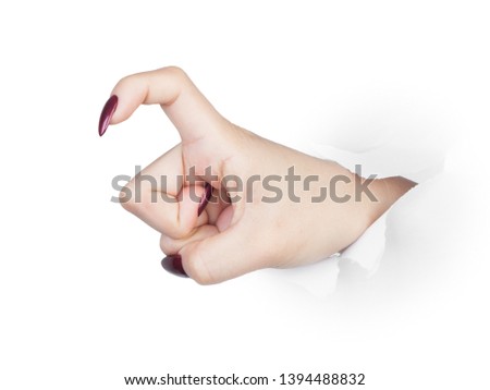 Female hand punches paper isolated on white background