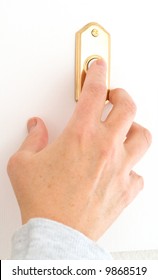 Female Hand Pushing The Doorbell Buzzer