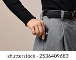 female hand putting black premium credit bank card in pants pocket. Money finance