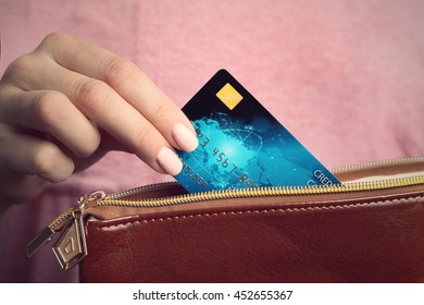 Female Hand Putting Credit Card In Wallet