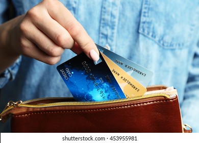 Female Hand Putting Credit Card In Wallet