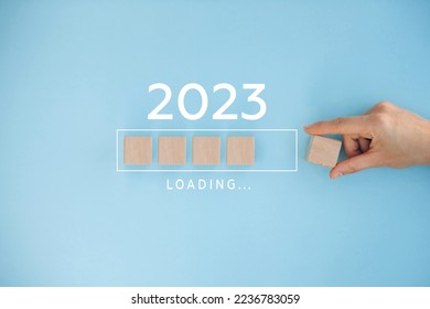 Female hand putting wooden cube for countdown to 2023. Loading year from 2022 to 2023. New year start concept - Shutterstock ID 2236783059