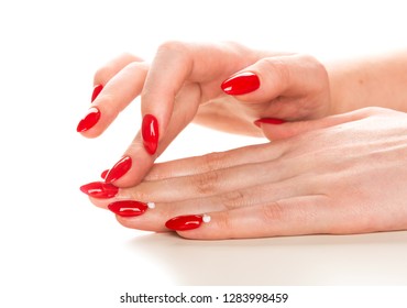 Female Hand With Red Manicure Applying Cream On Cuticle Isolated On White