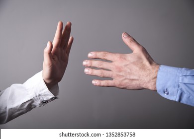 Female Hand Refusing Male Hand To Shake.