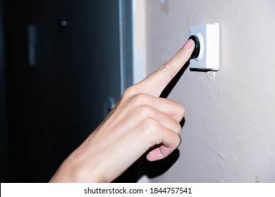 Female Hand Ringing The Doorbell Pressing A Button Closeup