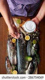 Female Hand Salted Fish And Home-cooked Marinade, Housewife Preparing Dinner For A Large Family