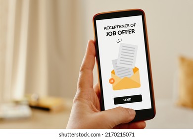 Female Hand Sending An Email From Mobile Phone To Accept A Job Offer.