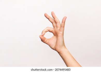 Female hand showing the ok gesture isolated on a white background. Okey hand sign - Shutterstock ID 2074495483