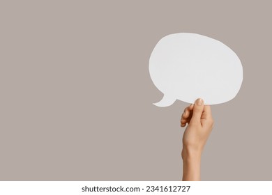 Female hand with speech bubble on grey background - Shutterstock ID 2341612727