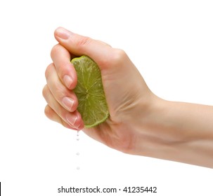 Female hand squeeze a lime. Isolation.