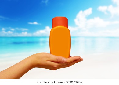 Female Hand With Suncream Bottle Background Blue Heaven