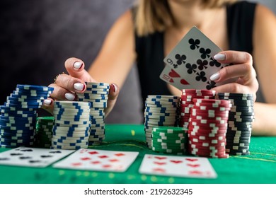 Female Hand Taking Poker Chips From Pile At Round Poker Table. Risky Bets In Poker