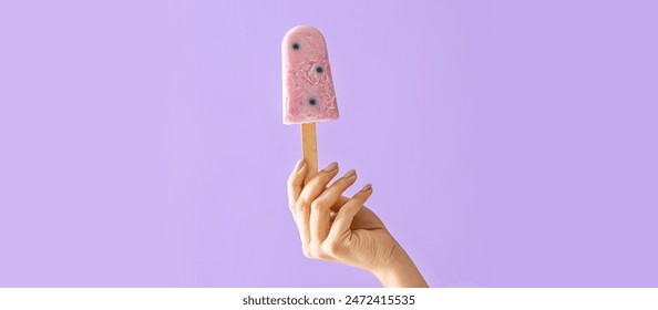 Female hand with tasty blueberry ice cream on lilac background - Powered by Shutterstock