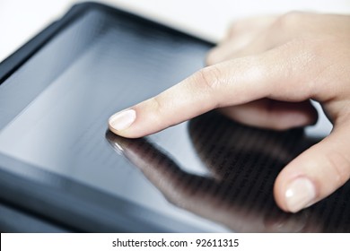 Female Hand Touching Tablet Computer Screen With Finger