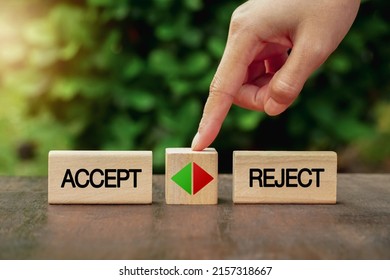 female hand touching a wooden cube with arrow icon between the options of accept or reject. The decision or choice between accepting or rejecting.  - Shutterstock ID 2157318667