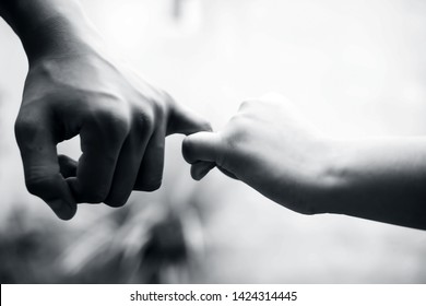 Female Hand Trying To Conquer Her Fears And Obstacles By Holding Male’s Hand. Concept Of Father’s Day And Women’s Day. Horizontal Shot With Bokeh Background. Losing The Grip Of The Elder.