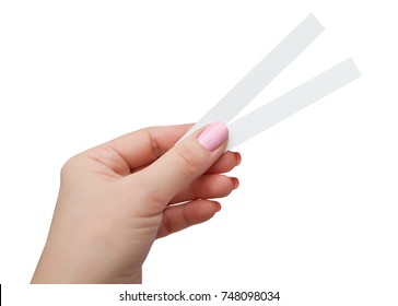 Female hand with two paper test strips for the perfume, isolated on white background