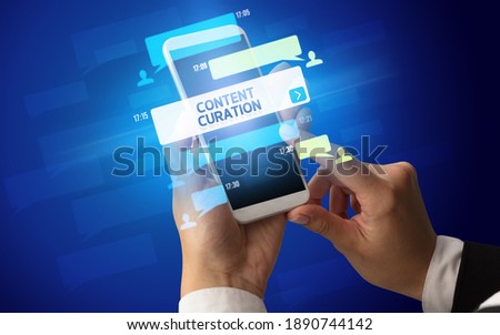 Female hand typing on smartphone with CONTENT CURATION inscription, social networking concept