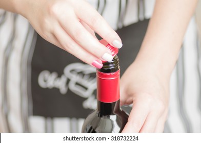 Female Hand Unscrews The Screw Cap Red Wine Bottle