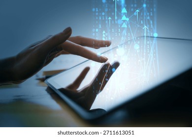 Female hand using tablet with binary code and arrows overlay, in creative blue light background, representing digital transformation concept