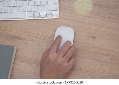 Female Hand Using Wireless Mouse At Work 