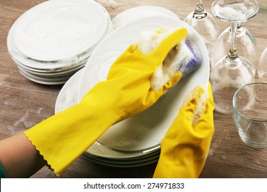 Female hand washing dish close up