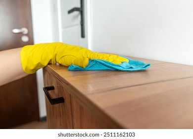 female hand wear gloves cleaning wooden furniture at house. Cleaning table - Powered by Shutterstock