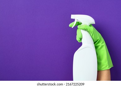 Female Hand With White Spray Bottle Mockup Over Purple Background. House Cleaning Service And Housekeeping Concept.