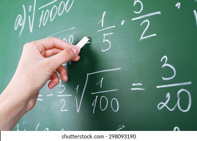Female Hand Writing Formulas On Blackboard With Chalk Close Up