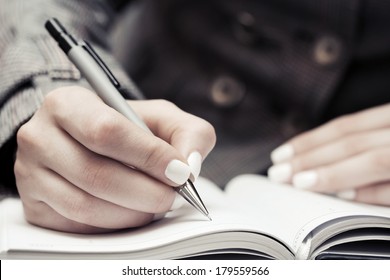 Female Hand Writing In Notebook 