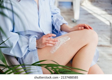 Female Hands Applying Purple Cream Scrub On Leg Skin After Shaving At Home. Morning Beauty Routine. Skincare Concept