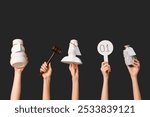 Female hands with auction paddle, gavel and antique items on dark background