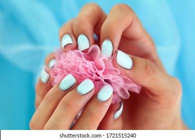 Female hands and beautiful gentle manicure  Summer trend  blue gradient the nails and gel polish  shellac  Short nails

