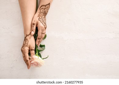 Female Hands With Beautiful Henna Tattoo And Rose Flower On Light Background, Closeup