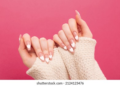 female hands with beautiful long nails with  manicure with  heart pattern in winter clothes - Shutterstock ID 2124123476