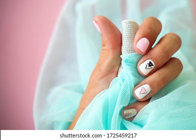 Female hands and beautiful manicure blue background  Summer trend  geometric pattern nails and gel polish  shellac  Short nails